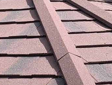 Close-up of reddish stone-coated Metrotile roof tiles